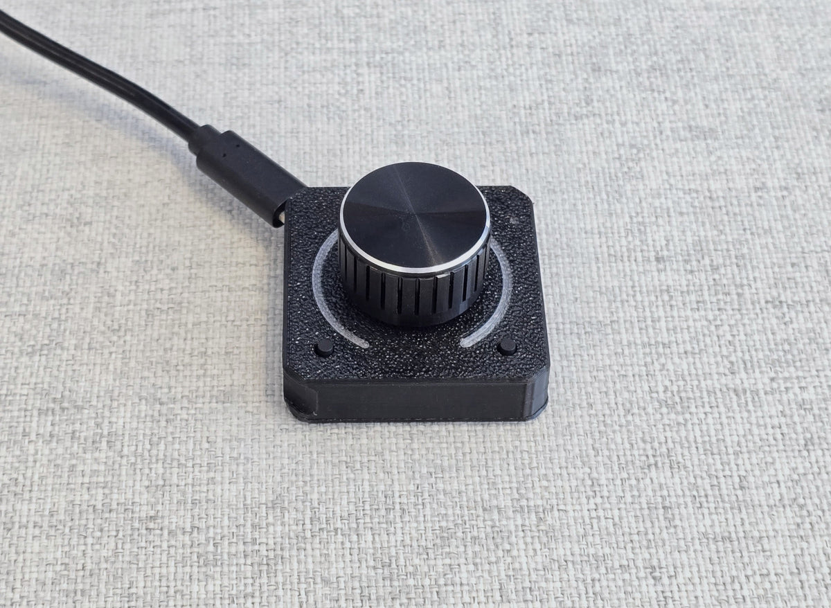 The 1ES2K with the LED ring off, showing the textured black housing and the plain metal knob
