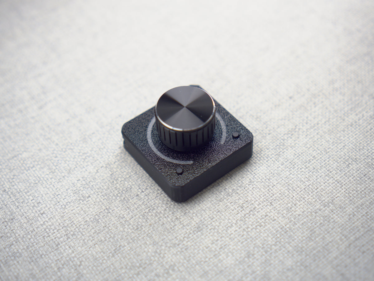 Close-up angled view of the 1ES2K showing the knurled metal knob and textured black housing