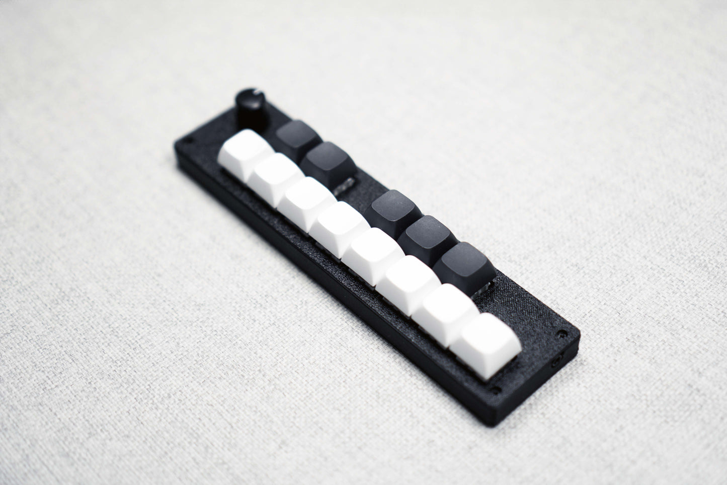The 13KS-1ES viewed from above at an angle, running away from the camera, with the corner screws visible on the black case