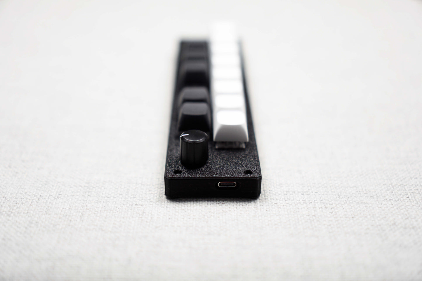 Close-up of the end of the 13KS-1ES with the USB-C port below the encoder knob